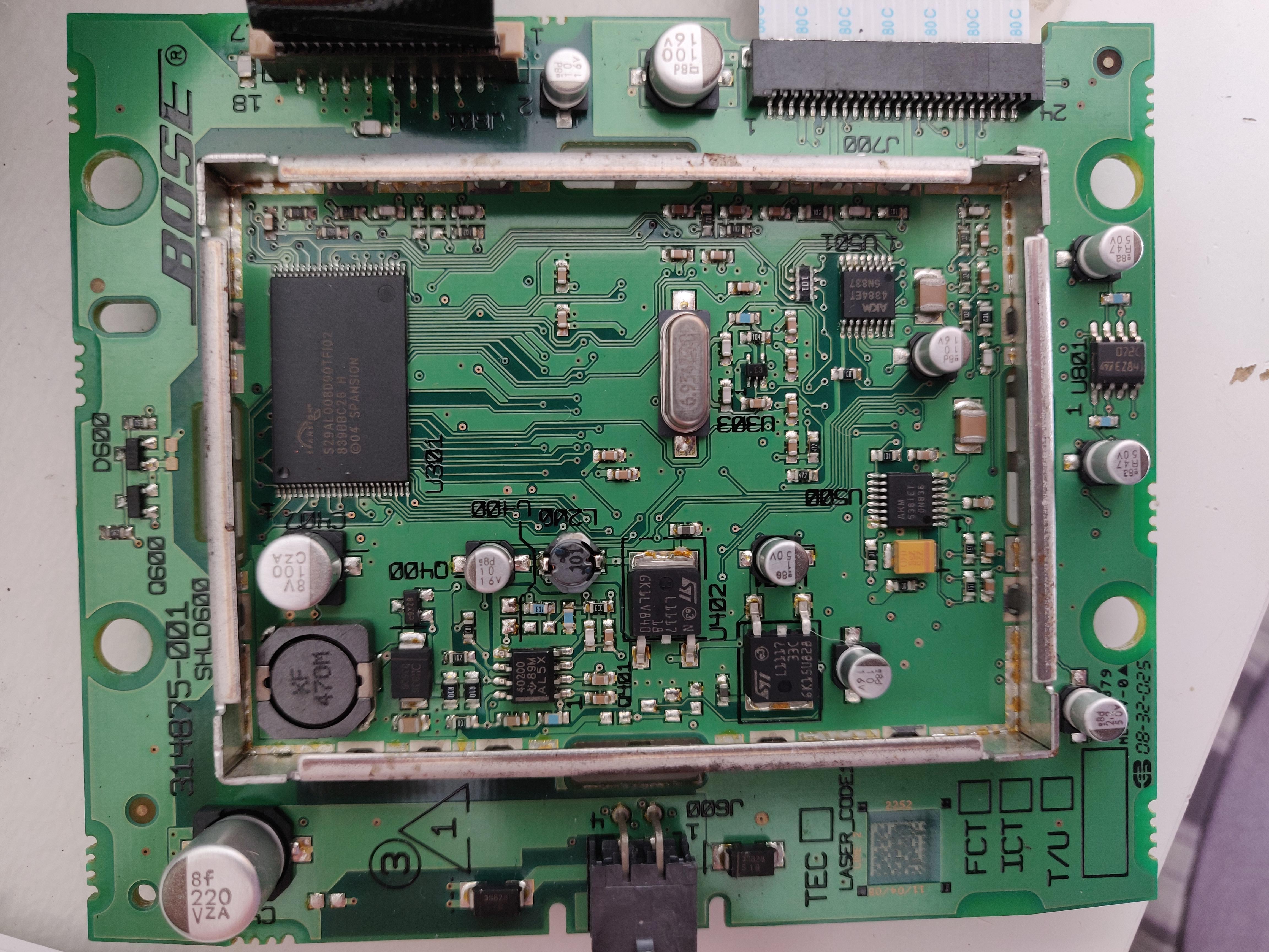 This is the 'Top' side of the mainboard. Top Left: Ribbon to Amp Board, Top Right: Ribbon from Dock Board. Within the EMC can is the Spansion Flash. Bottom: Power input — looks like a 4-pin Molex Mini Fit Jr. Bose mainboard — top side